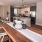 spacious dining area with wooden floors next to kitchen
