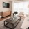 roomy living room with large windows, plush carpet, and is next to kitchen
